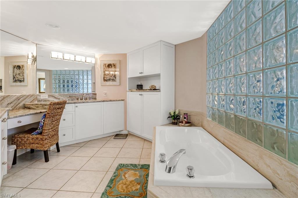 4041 Gulf Shore Boulevard North, Unit PH4 Naples, FL 34103 - Photo 27 of 35 a bathroom with a bathtub and a sink