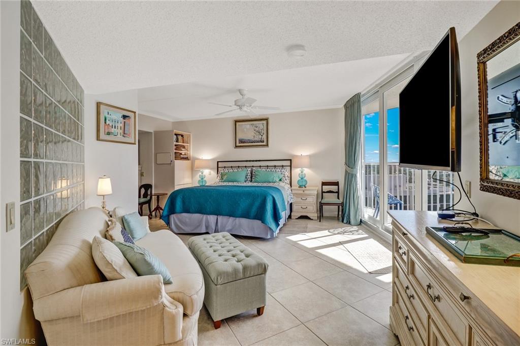 4041 Gulf Shore Boulevard North, Unit PH4 Naples, FL 34103 - Photo 30 of 35 a bedroom with furniture and a flat screen tv