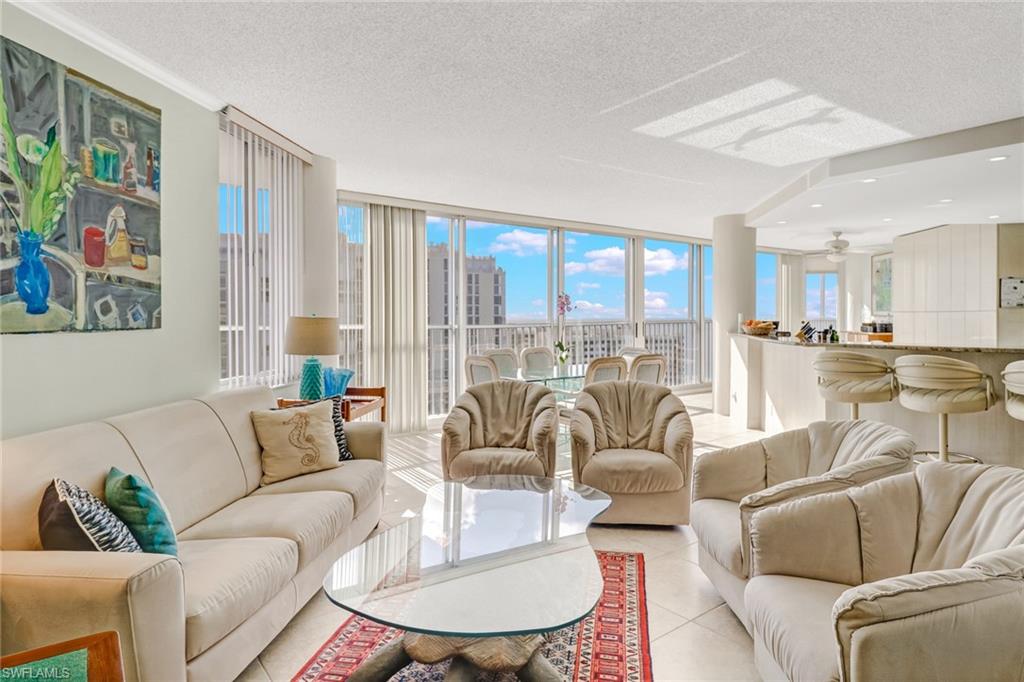 4041 Gulf Shore Boulevard North, Unit PH4 Naples, FL 34103 - Photo 6 of 35 a living room with furniture and a large window