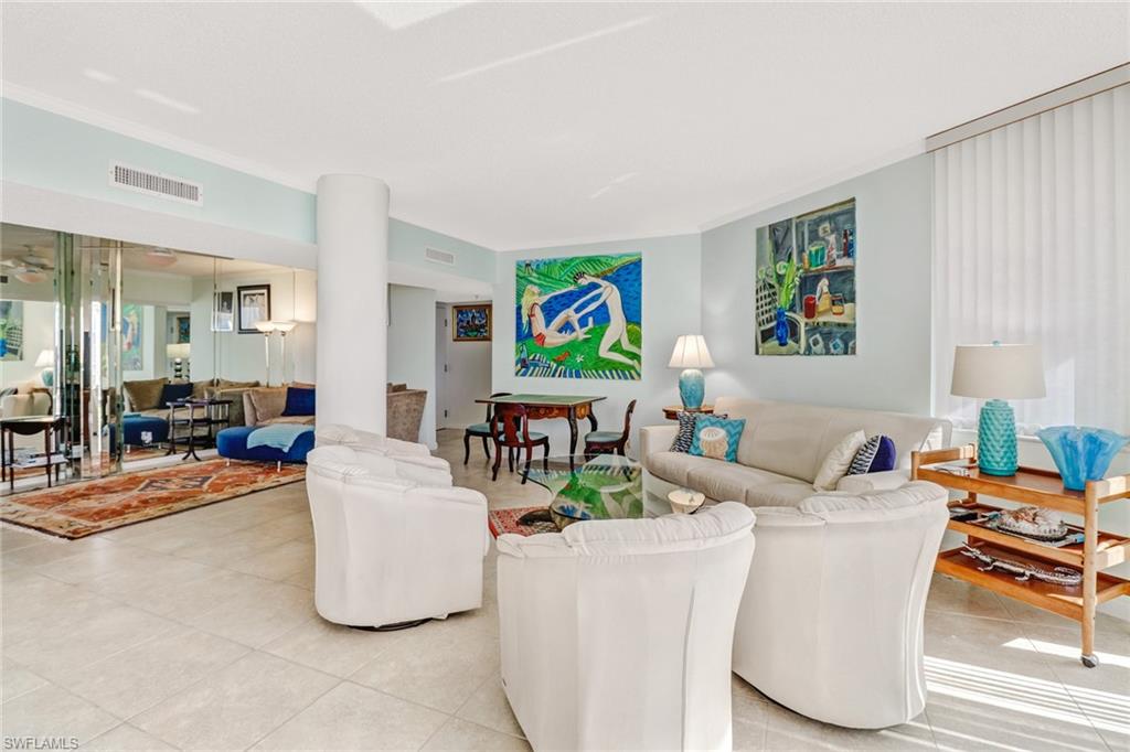 4041 Gulf Shore Boulevard North, Unit PH4 Naples, FL 34103 - Photo 7 of 35 a living room with furniture and a table