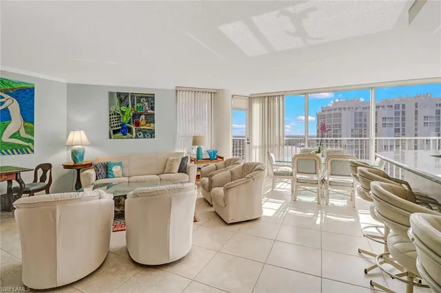 a living room with furniture a flat screen tv and a large window