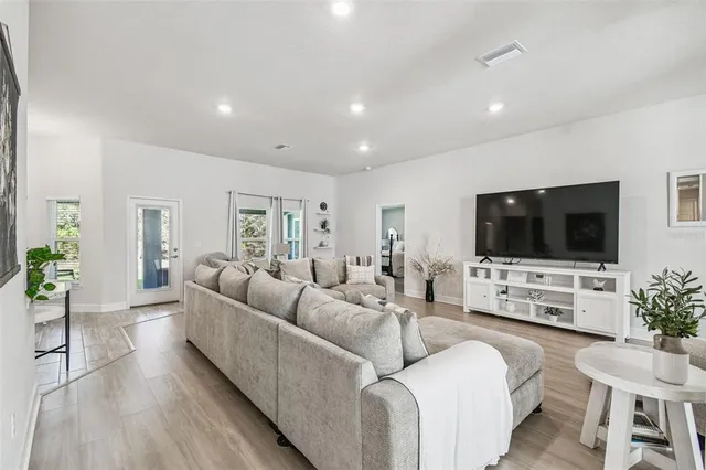 a living room with furniture and wooden floor