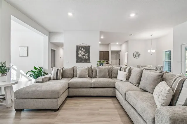 a kitchen with kitchen island a table and chairs in it