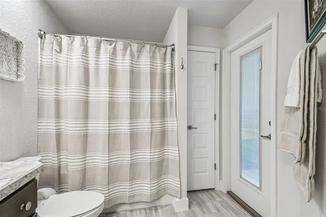 a spacious bathroom with a toilet sink and mirror