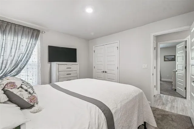 a bedroom with a bed and a mirror