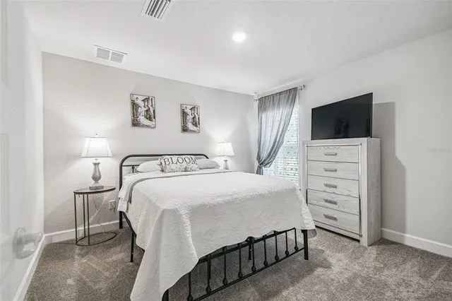 a bedroom with a bed and a lamp