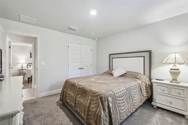 a view of a hallway with a livingroom and a bathroom with sink