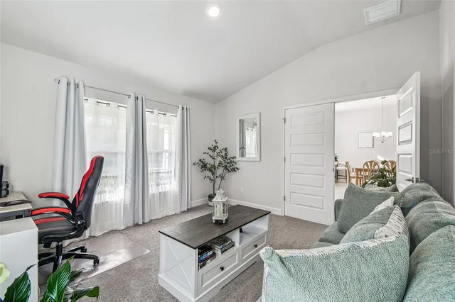 a spacious bedroom with a bed and a couch