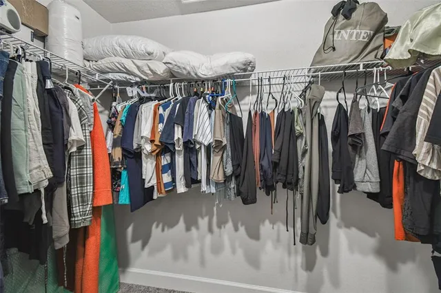 a bathroom with a tub a sink and wooden floor