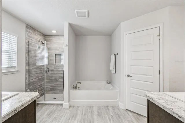 a white toilet sitting next to a white wall