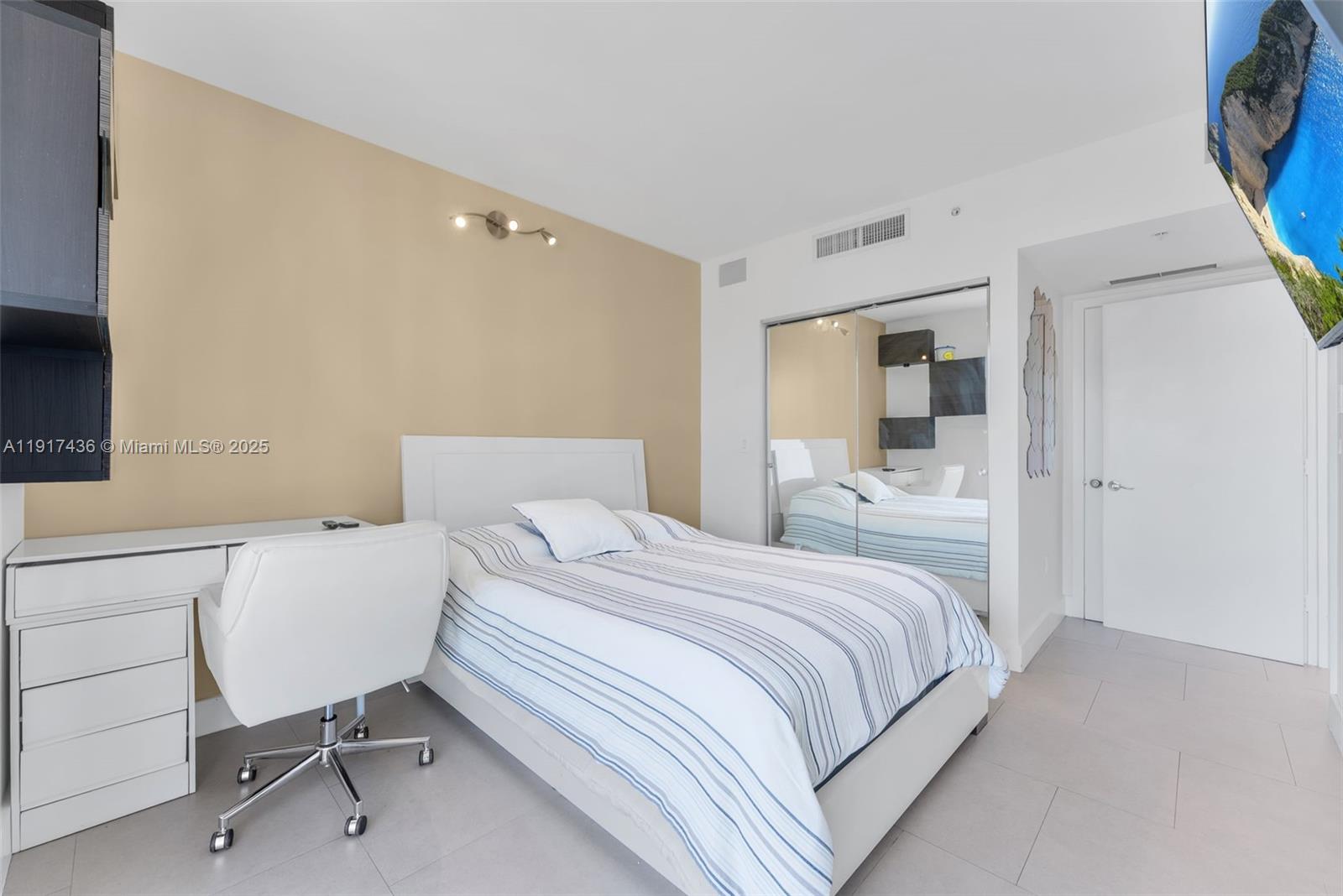 92 Southwest 3rd Street, Unit 3611 Miami, FL 33130 - Photo 11 of 18 a bedroom with a bed and a chair