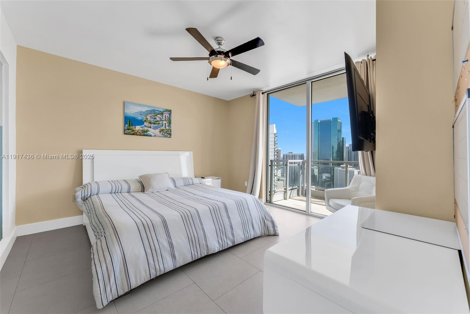92 Southwest 3rd Street, Unit 3611 Miami, FL 33130 - Photo 12 of 18 a bedroom with a large bed and a glass door