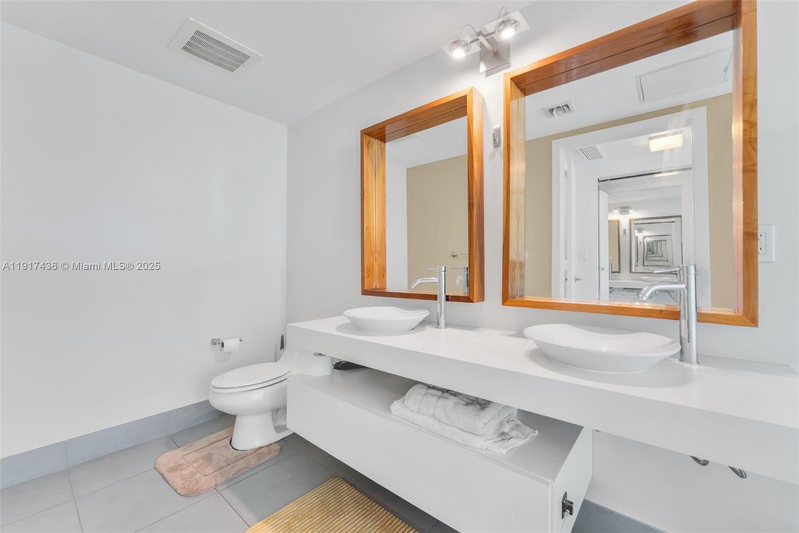 92 Southwest 3rd Street, Unit 3611 Miami, FL 33130 - Photo 14 of 18 a bathroom with a sink and a mirror