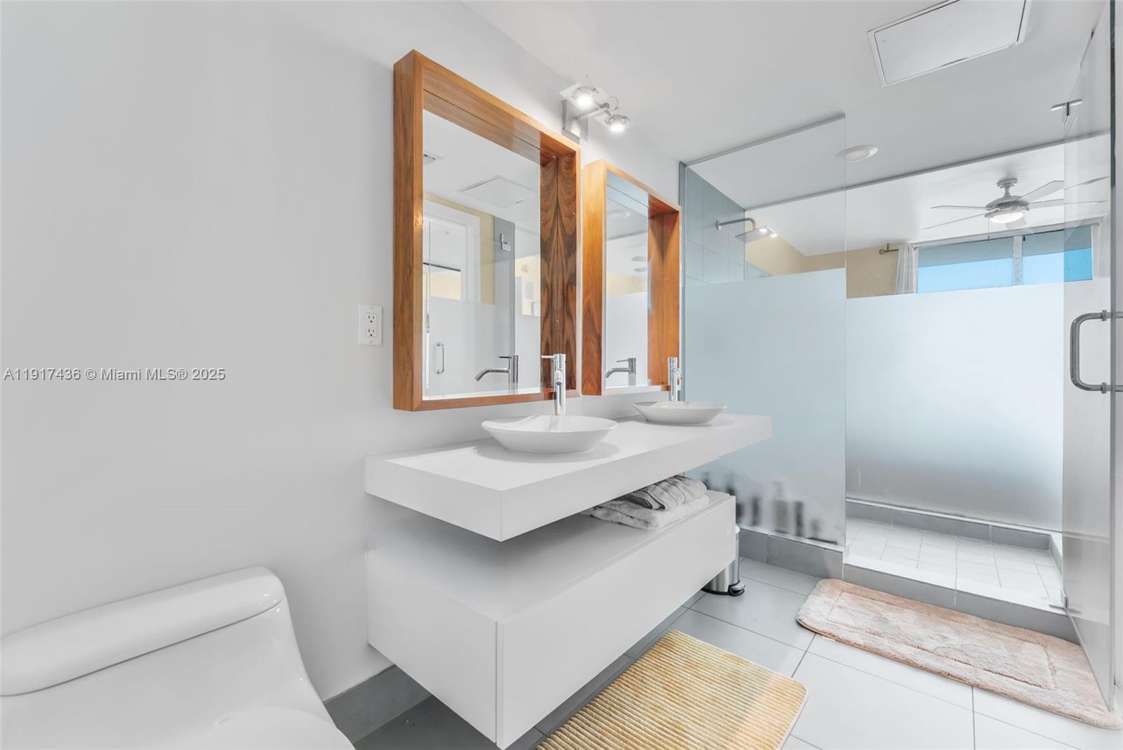 92 Southwest 3rd Street, Unit 3611 Miami, FL 33130 - Photo 16 of 18 a bathroom with a sink a toilet and a large mirror