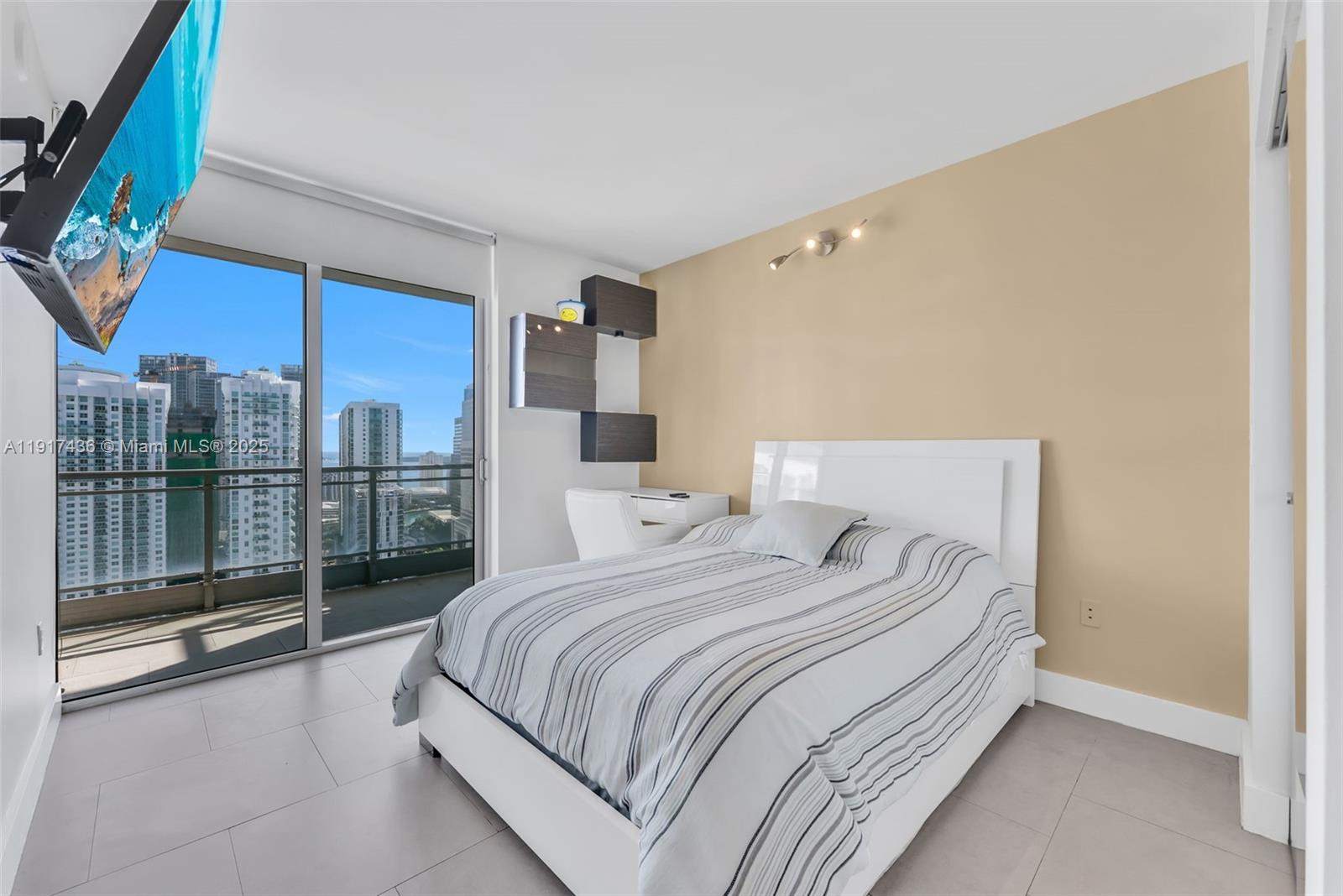 92 Southwest 3rd Street, Unit 3611 Miami, FL 33130 - Photo 10 of 18 a bedroom with a balcony a bed and a night stand