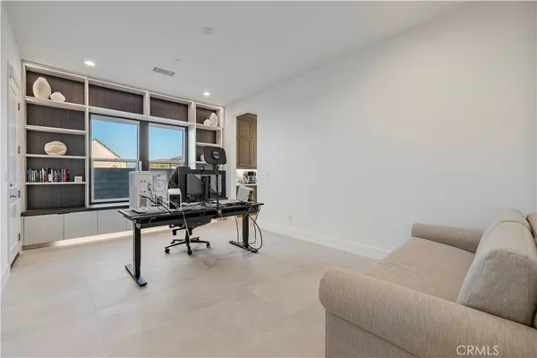 a bedroom with furniture and a large window