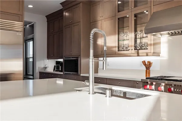 a kitchen with a sink and a stove top oven