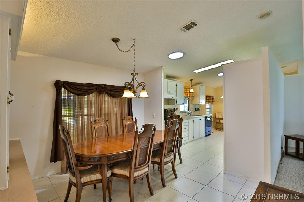 720 Navigators Way Edgewater, FL 32141 - Photo 11 of 35 a dining room with furniture and window