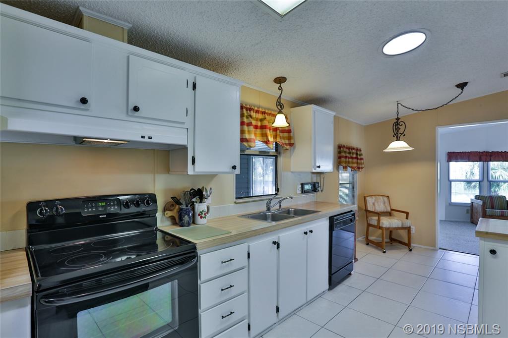 720 Navigators Way Edgewater, FL 32141 - Photo 12 of 35 a kitchen with a stove and a sink