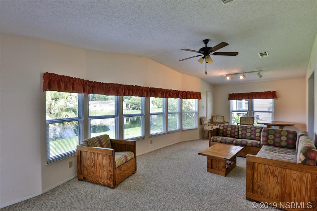 720 Navigators Way Edgewater, FL 32141 - Photo 16 of 35 a living room with furniture and a large window