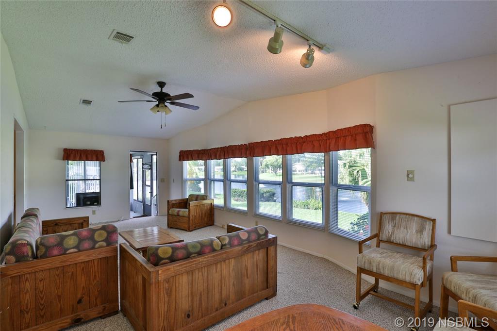 720 Navigators Way Edgewater, FL 32141 - Photo 17 of 35 a living room with furniture and a large window