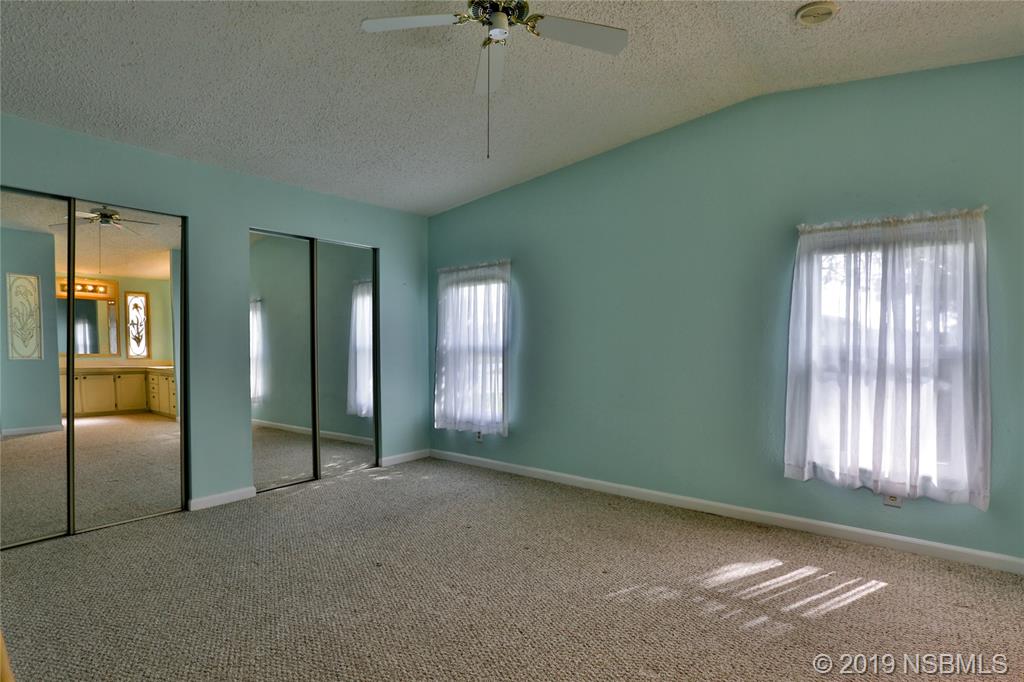 720 Navigators Way Edgewater, FL 32141 - Photo 18 of 35 an empty room with windows and closet