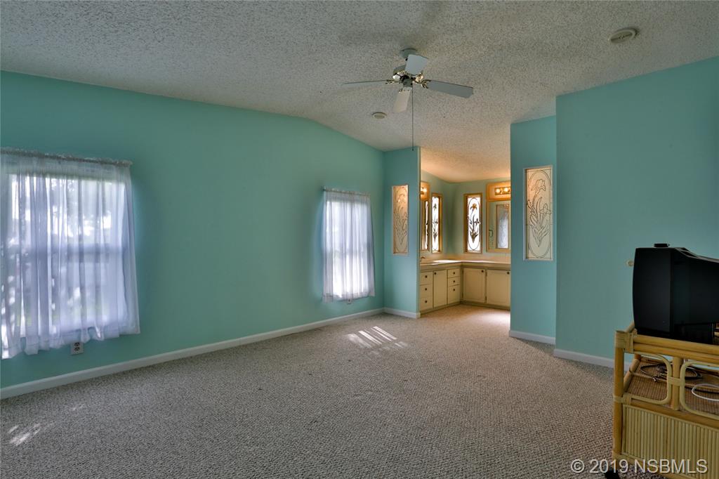 720 Navigators Way Edgewater, FL 32141 - Photo 19 of 35 a view of an empty room with a window and fireplace
