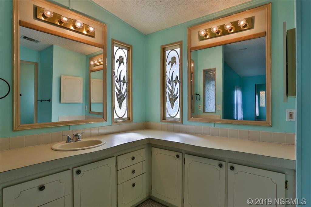 720 Navigators Way Edgewater, FL 32141 - Photo 20 of 35 a bathroom with double vanity sink and a mirror
