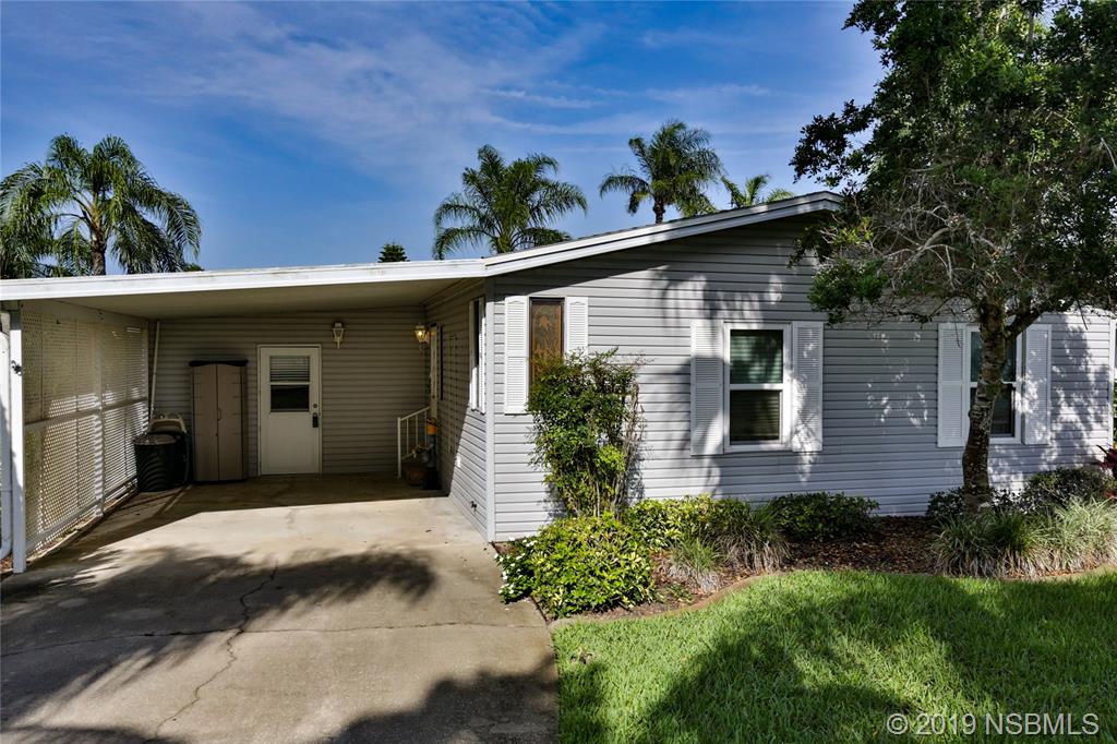 720 Navigators Way Edgewater, FL 32141 - Photo 3 of 35 a front view of a house with a yard