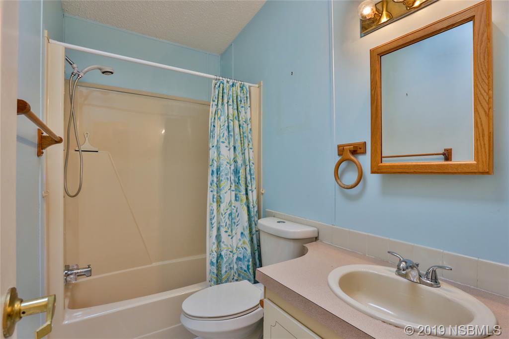 720 Navigators Way Edgewater, FL 32141 - Photo 24 of 35 a bathroom with a sink toilet and shower