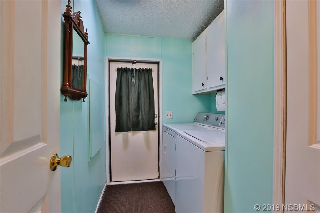 720 Navigators Way Edgewater, FL 32141 - Photo 25 of 35 a bathroom with a sink and mirror