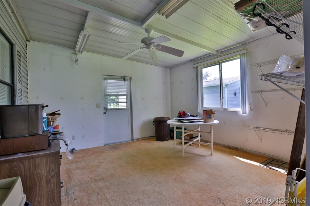 720 Navigators Way Edgewater, FL 32141 - Photo 27 of 35 a work room with furniture a flat screen tv and a window