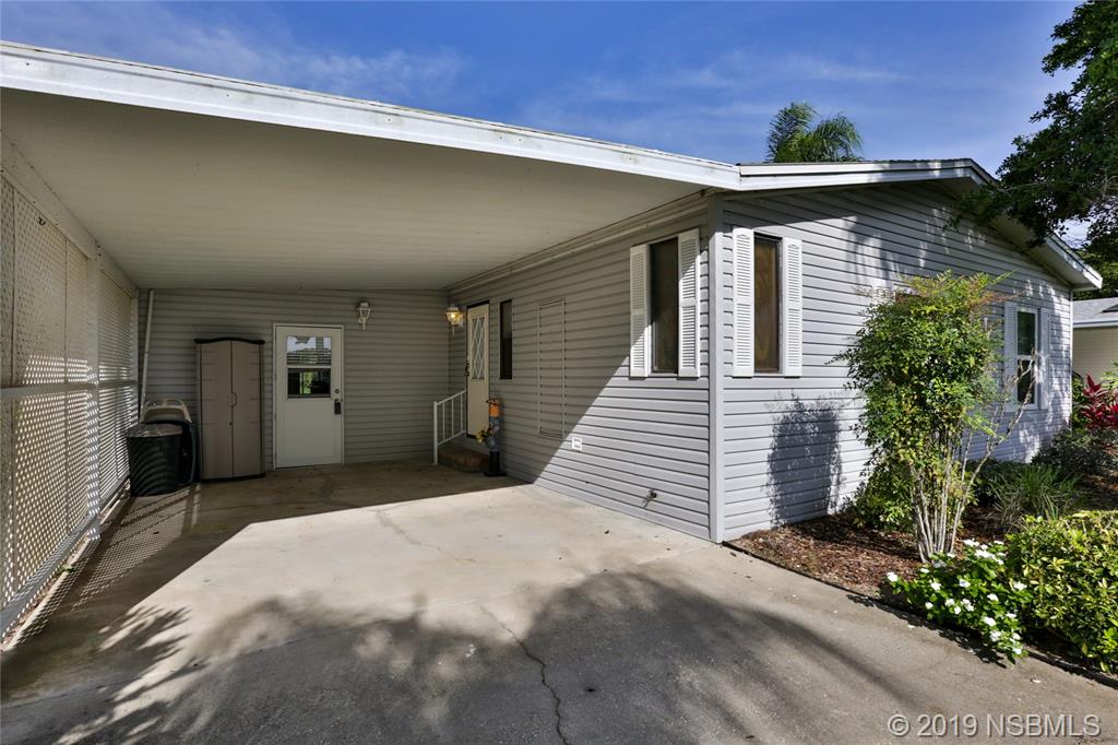 720 Navigators Way Edgewater, FL 32141 - Photo 4 of 35 a front view of a house with a yard