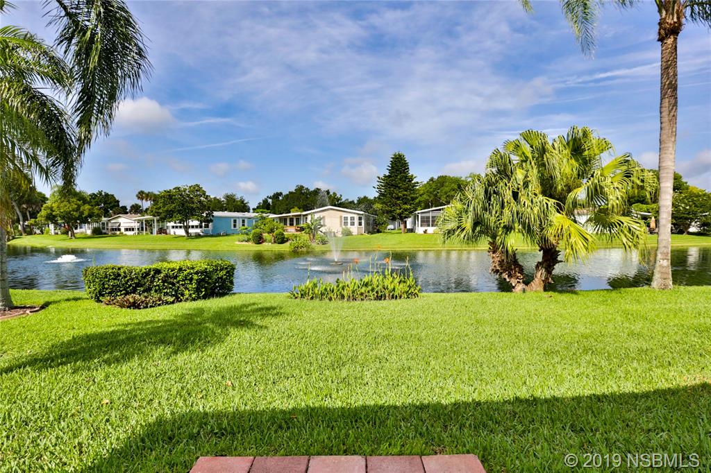 720 Navigators Way Edgewater, FL 32141 - Photo 31 of 35 a view of a golf course with a lake view