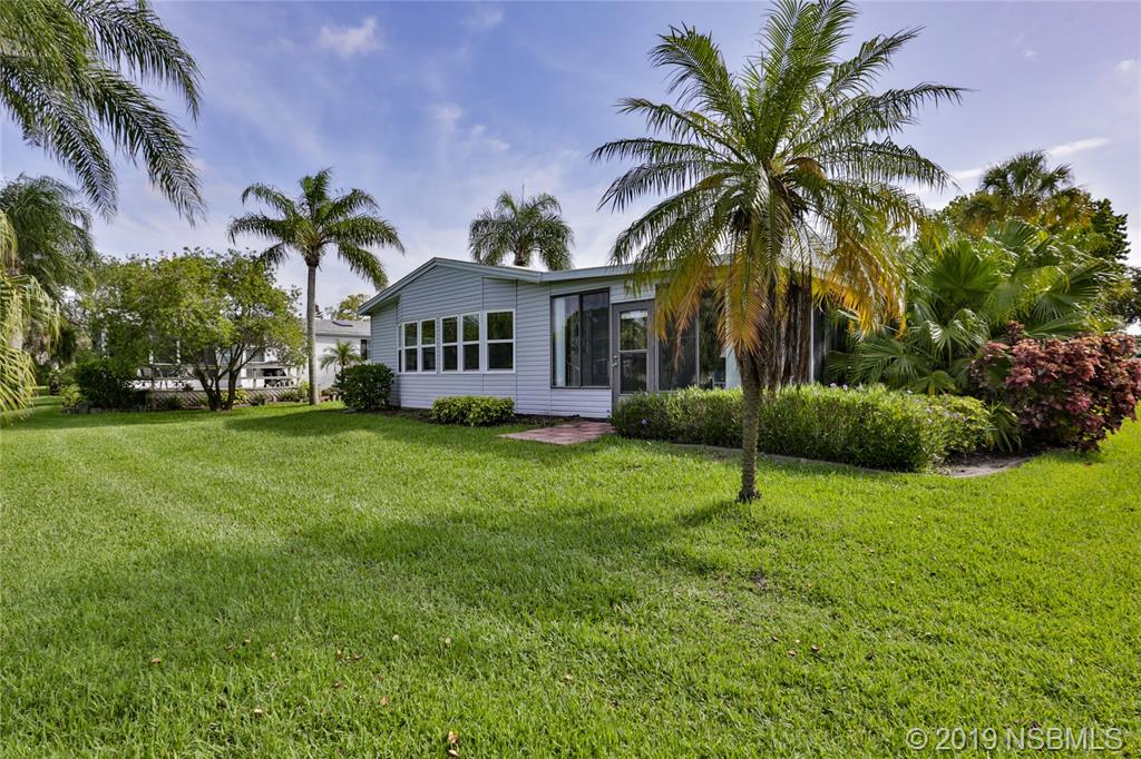 720 Navigators Way Edgewater, FL 32141 - Photo 32 of 35 a front view of house with yard and green space
