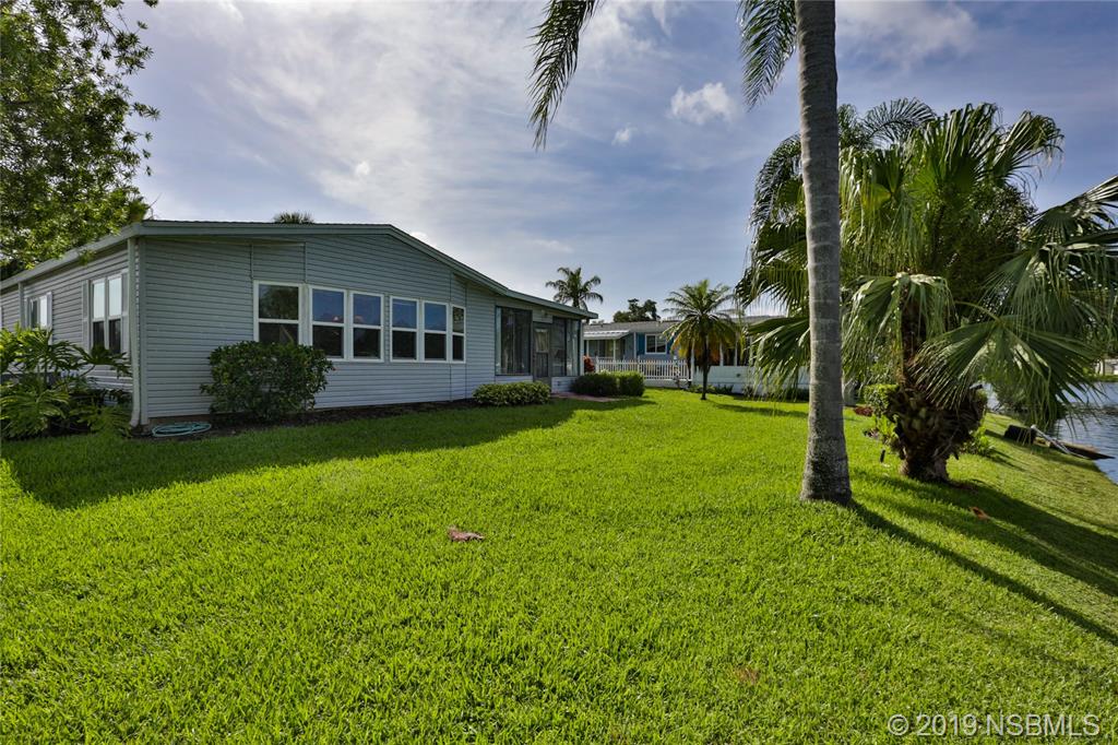 720 Navigators Way Edgewater, FL 32141 - Photo 34 of 35 a view of a house with backyard and garden