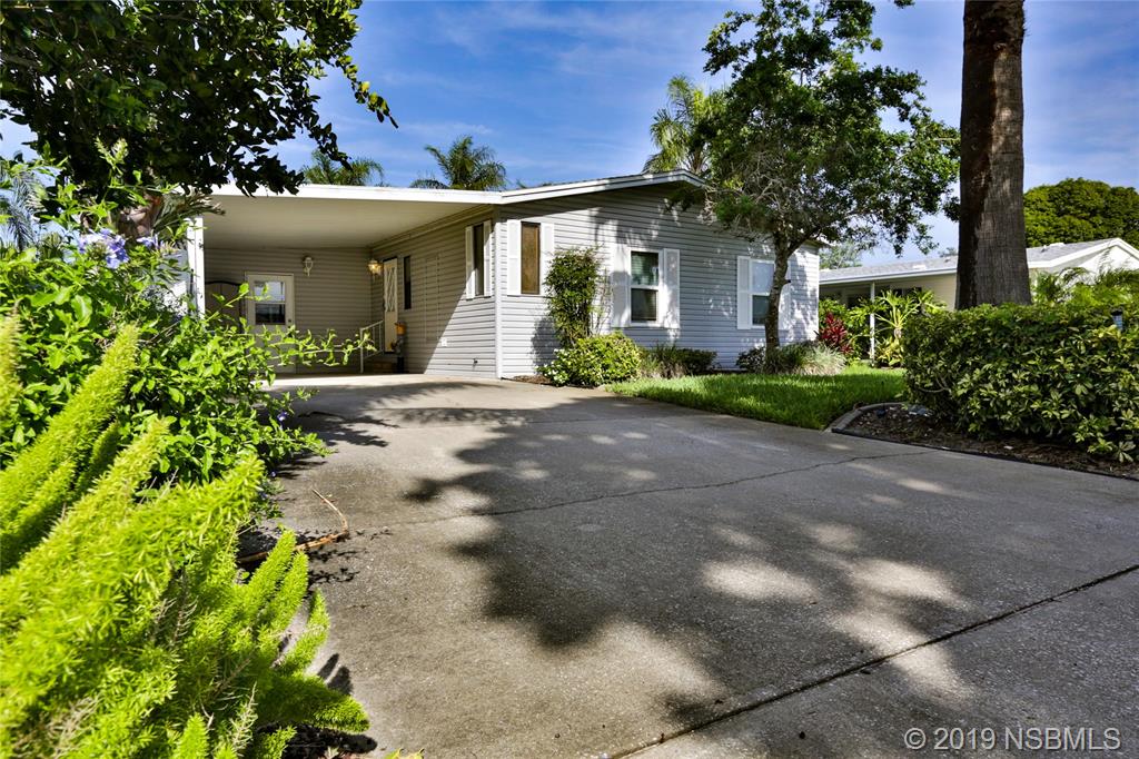 720 Navigators Way Edgewater, FL 32141 - Photo 5 of 35 a front view of a house with a garden