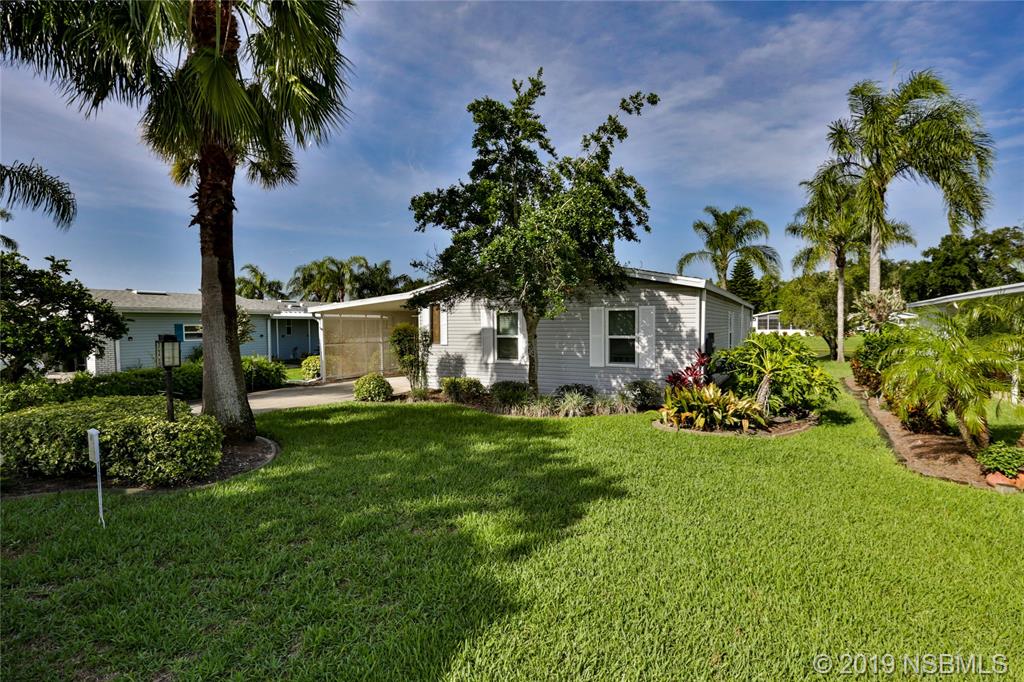 720 Navigators Way Edgewater, FL 32141 - Photo 6 of 35 a front view of a house with garden