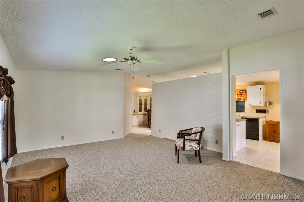 720 Navigators Way Edgewater, FL 32141 - Photo 7 of 35 a view of a livingroom with a furniture and chandelier
