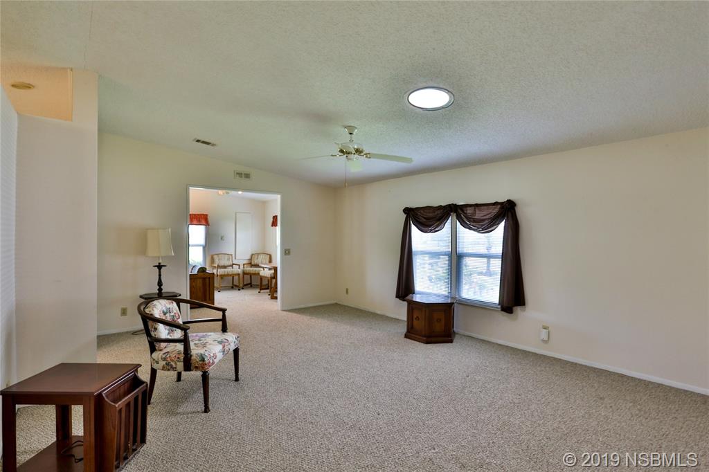 720 Navigators Way Edgewater, FL 32141 - Photo 9 of 35 a view of a livingroom with workspace and a window