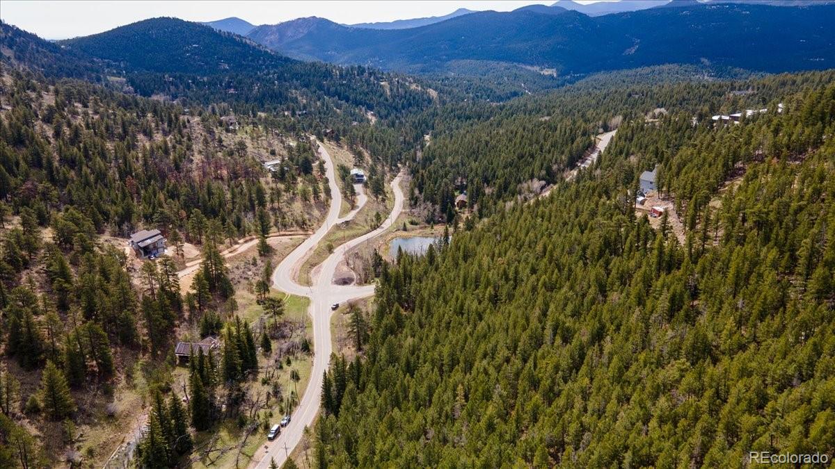 1521 Witter Gulch Road Evergreen, CO 80439 - Photo 2 of 20 a view of a city with mountain view
