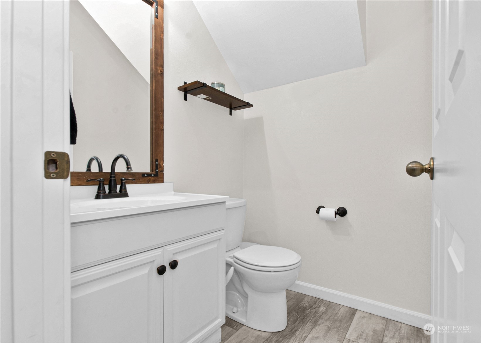 4619 211th Street East Spanaway, WA 98387 - Photo 12 of 36 a bathroom with a sink a toilet and a mirror