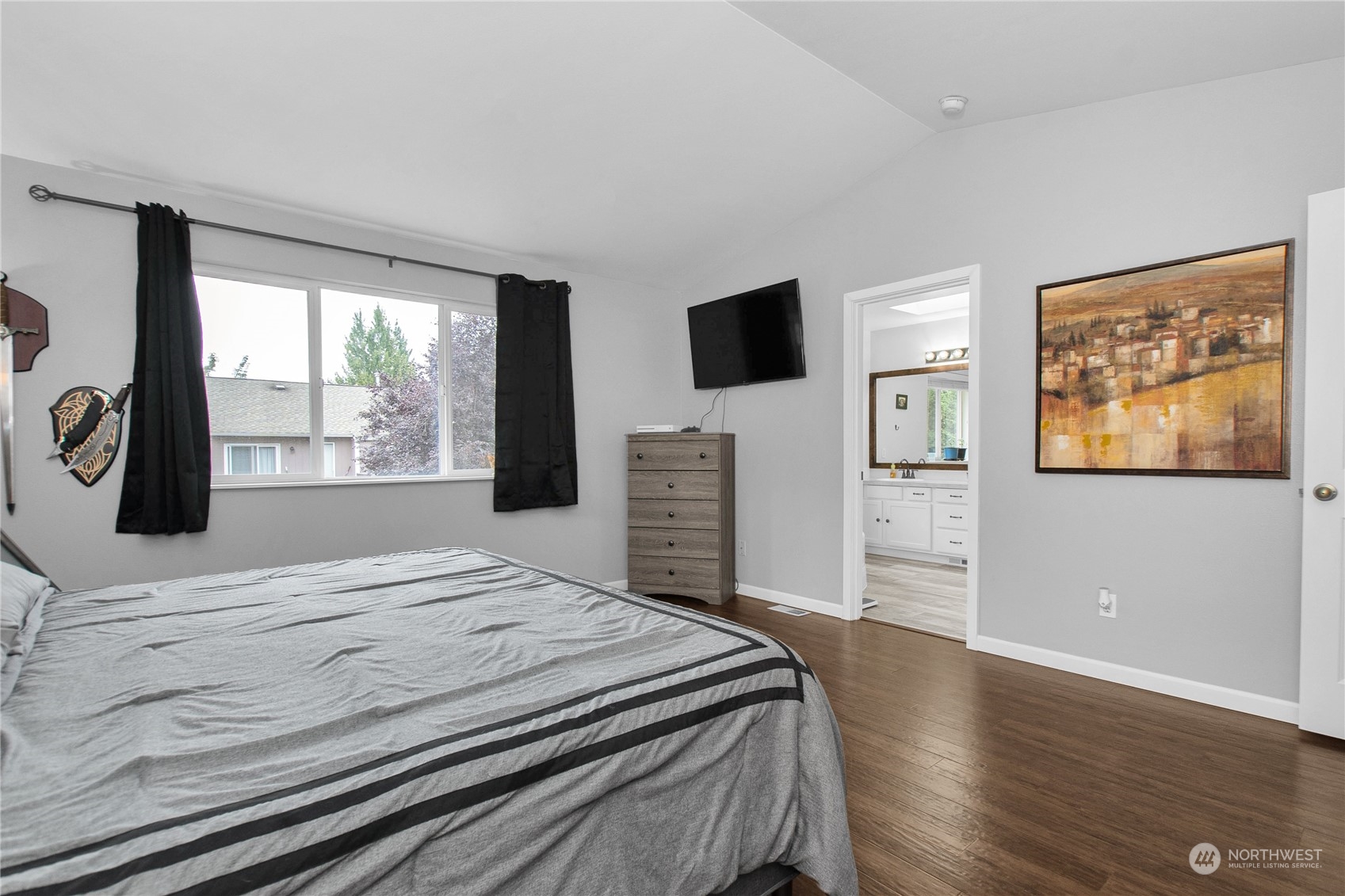 4619 211th Street East Spanaway, WA 98387 - Photo 22 of 36 a bedroom with a bed and a flat screen tv