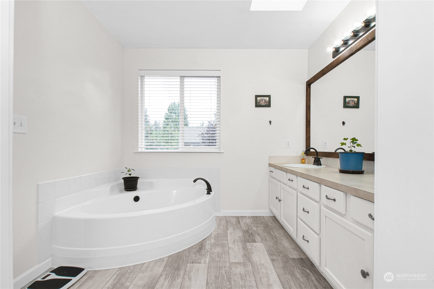 4619 211th Street East Spanaway, WA 98387 - Photo 25 of 36 a bathroom with a tub sink and mirror