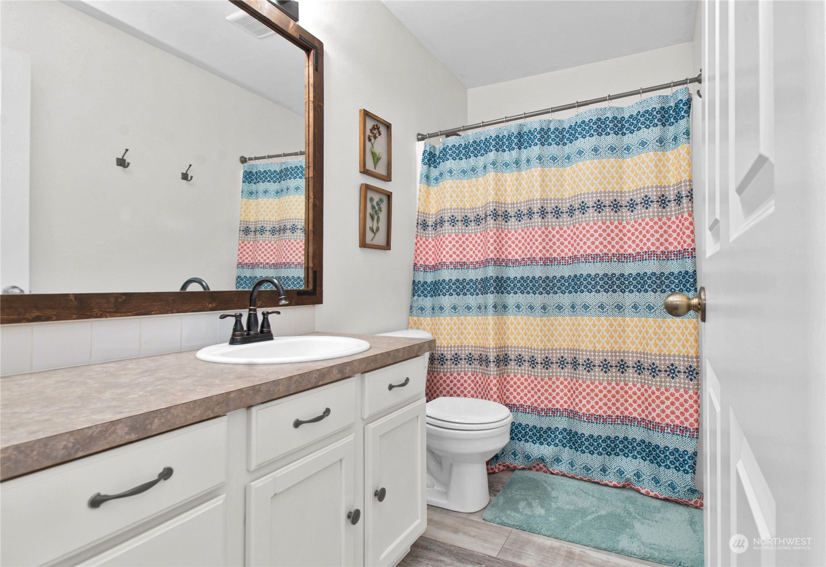 4619 211th Street East Spanaway, WA 98387 - Photo 27 of 36 a bathroom with a granite countertop sink and a mirror