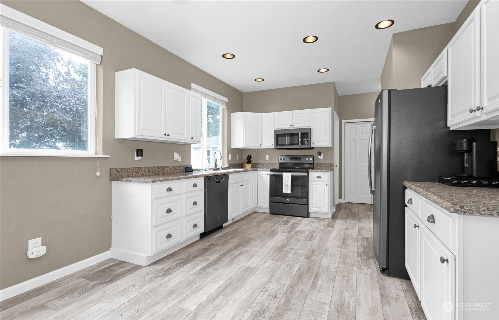 4619 211th Street East Spanaway, WA 98387 - Photo 3 of 36 a kitchen with granite countertop a sink stainless steel appliances and window
