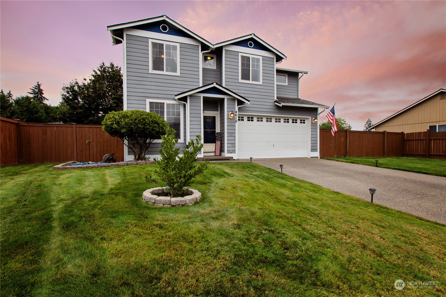 4619 211th Street East Spanaway, WA 98387 - Photo 35 of 36 a front view of a house with a yard and garage