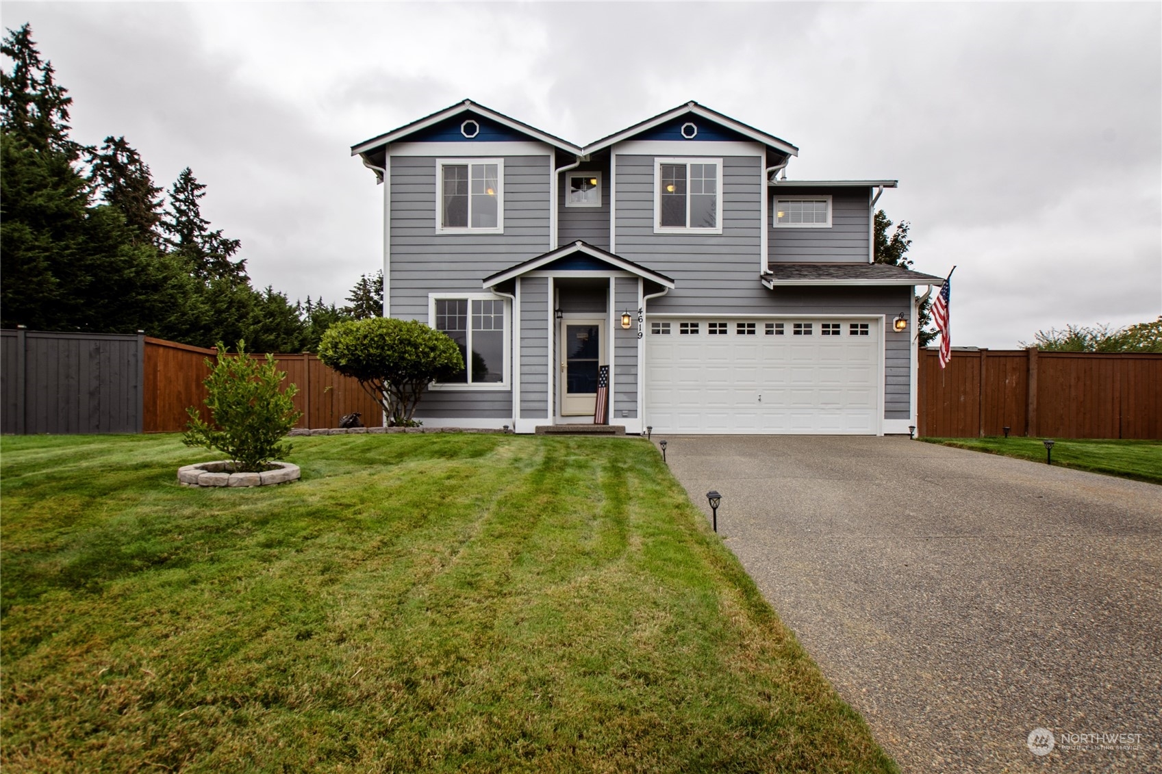 4619 211th Street East Spanaway, WA 98387 - Photo 36 of 36 a front view of a house with a yard and garage