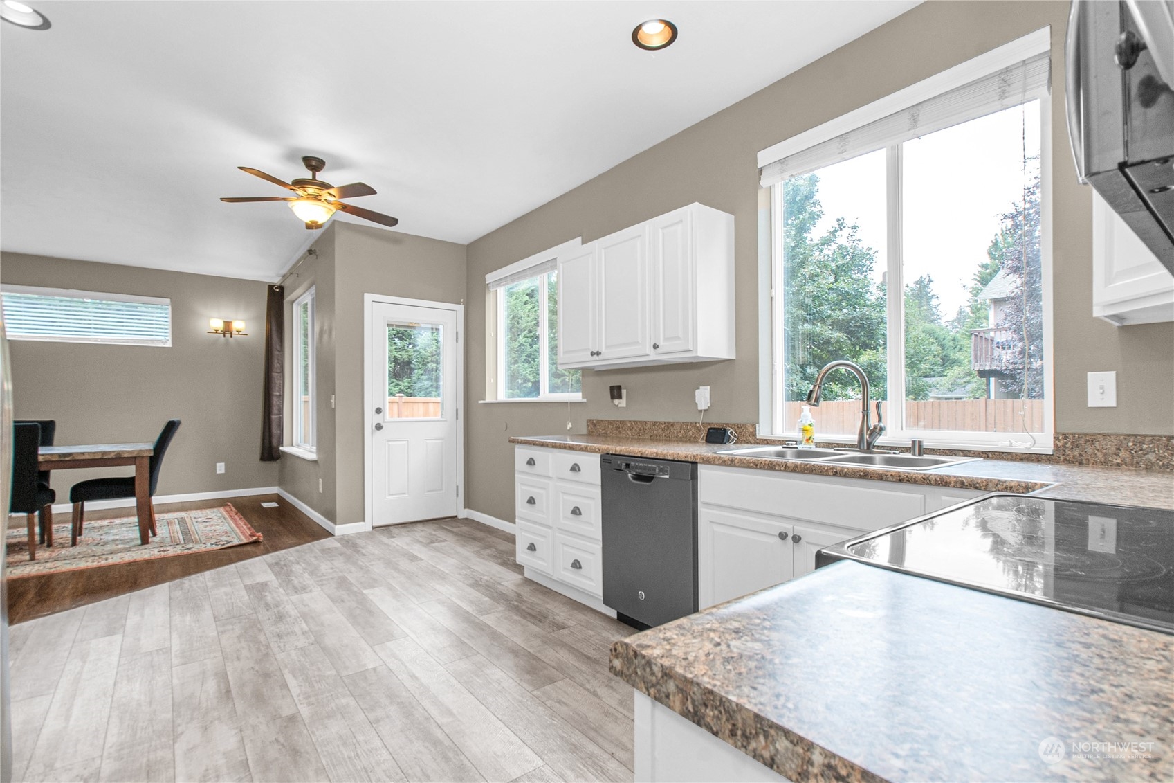 4619 211th Street East Spanaway, WA 98387 - Photo 5 of 36 a kitchen with a stove a sink and a refrigerator