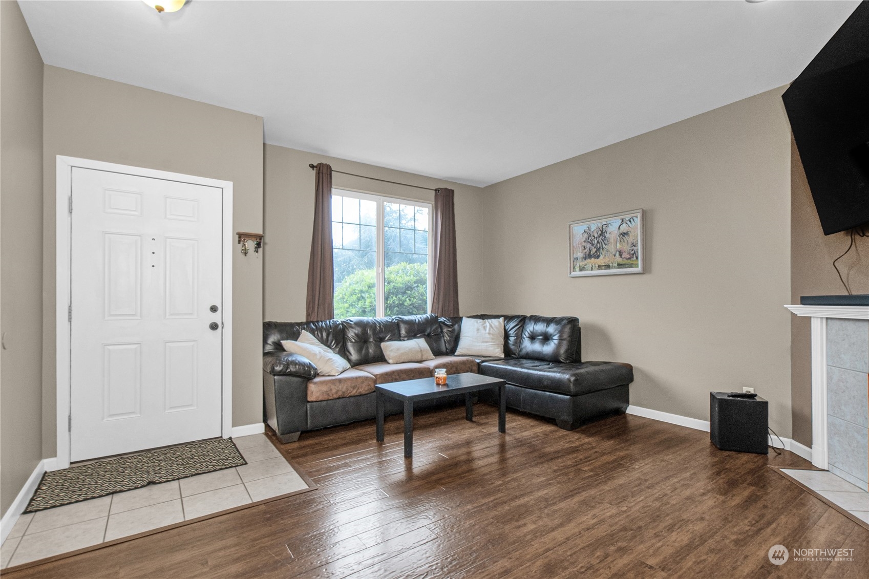 4619 211th Street East Spanaway, WA 98387 - Photo 10 of 36 a living room with furniture and a flat screen tv